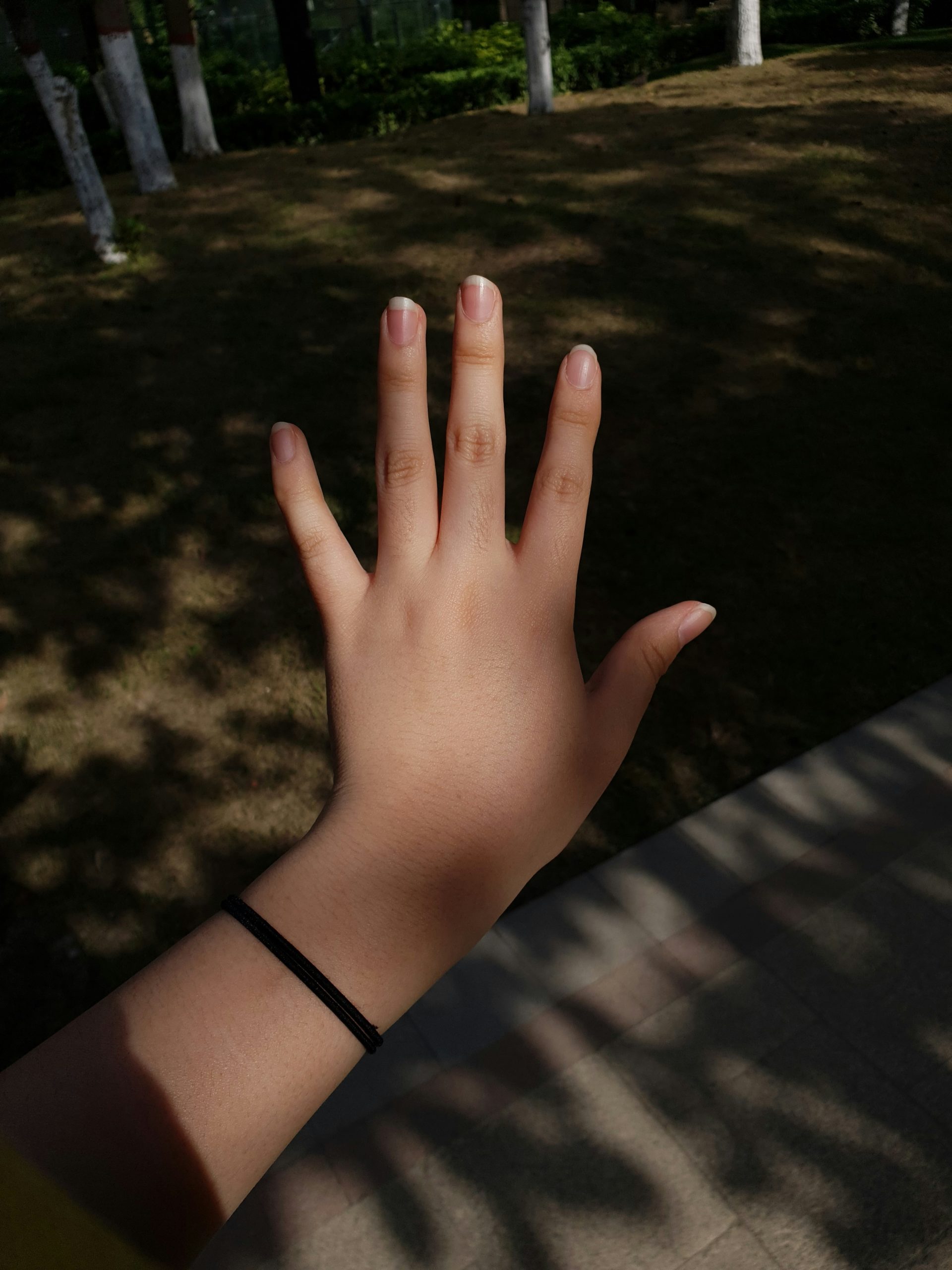 Close up photo of a senior hand gripping a light dumbbell with focused determination