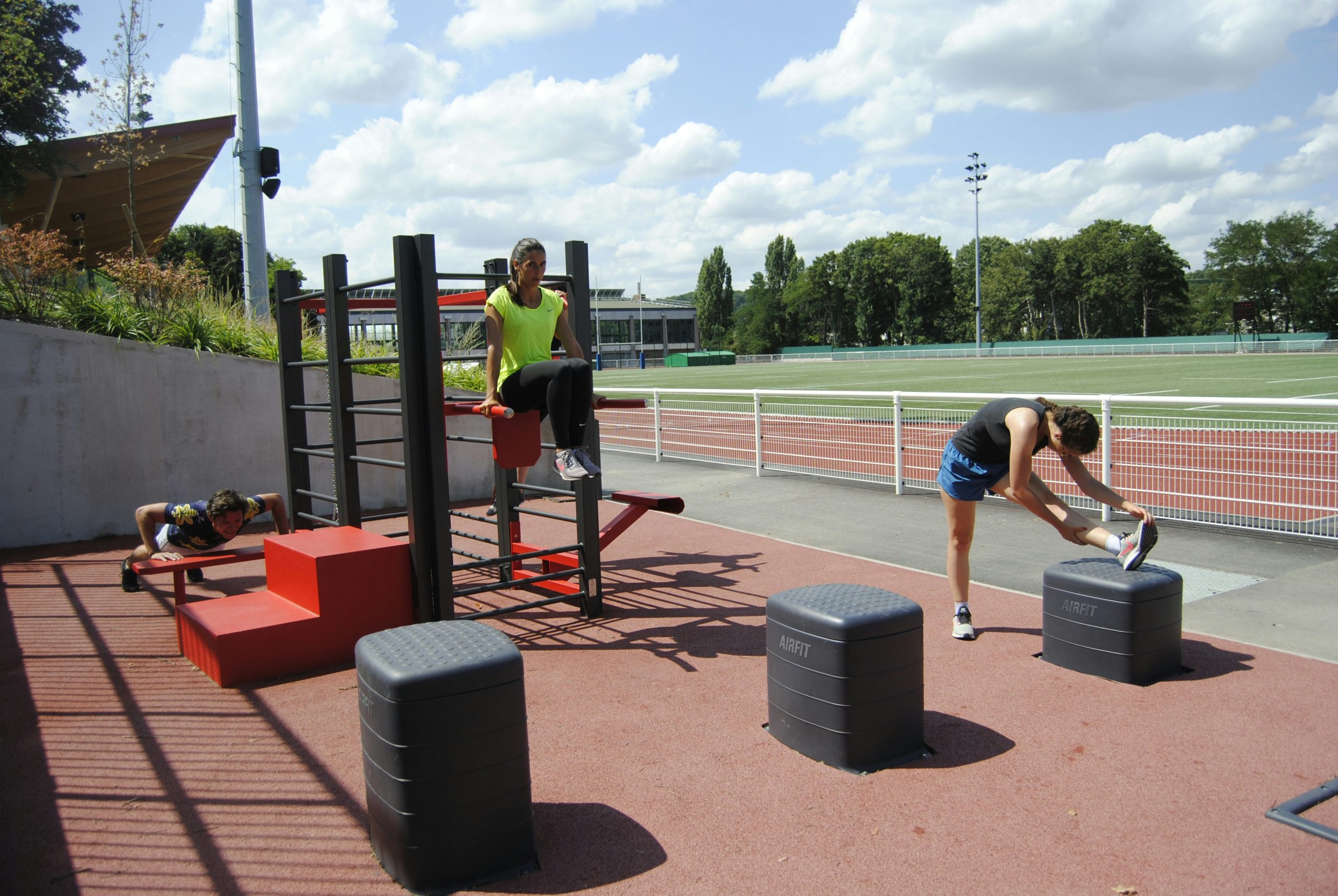 Athletes lifting weights during a cross-training group session, capturing the energy and focus.