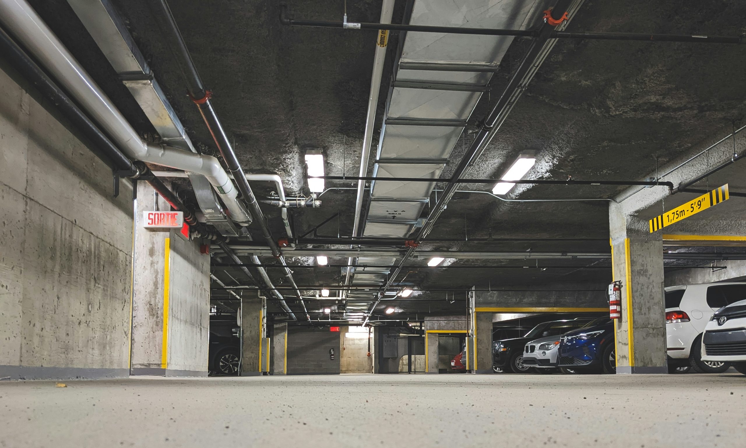 Underground parking garage with clear signs and available spots