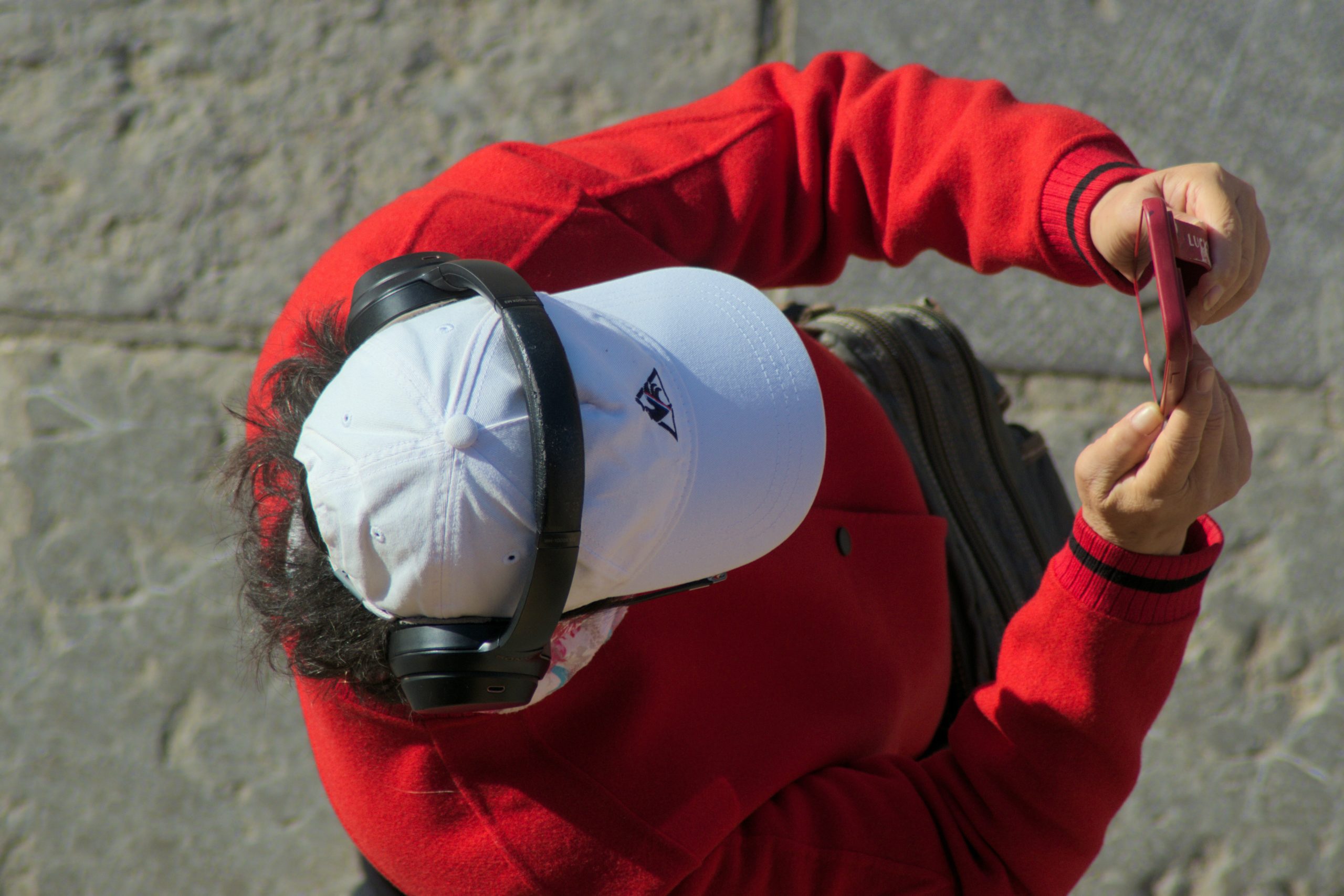 Close up of a coach correcting the posture of a member using a kettlebell, showing focus and care