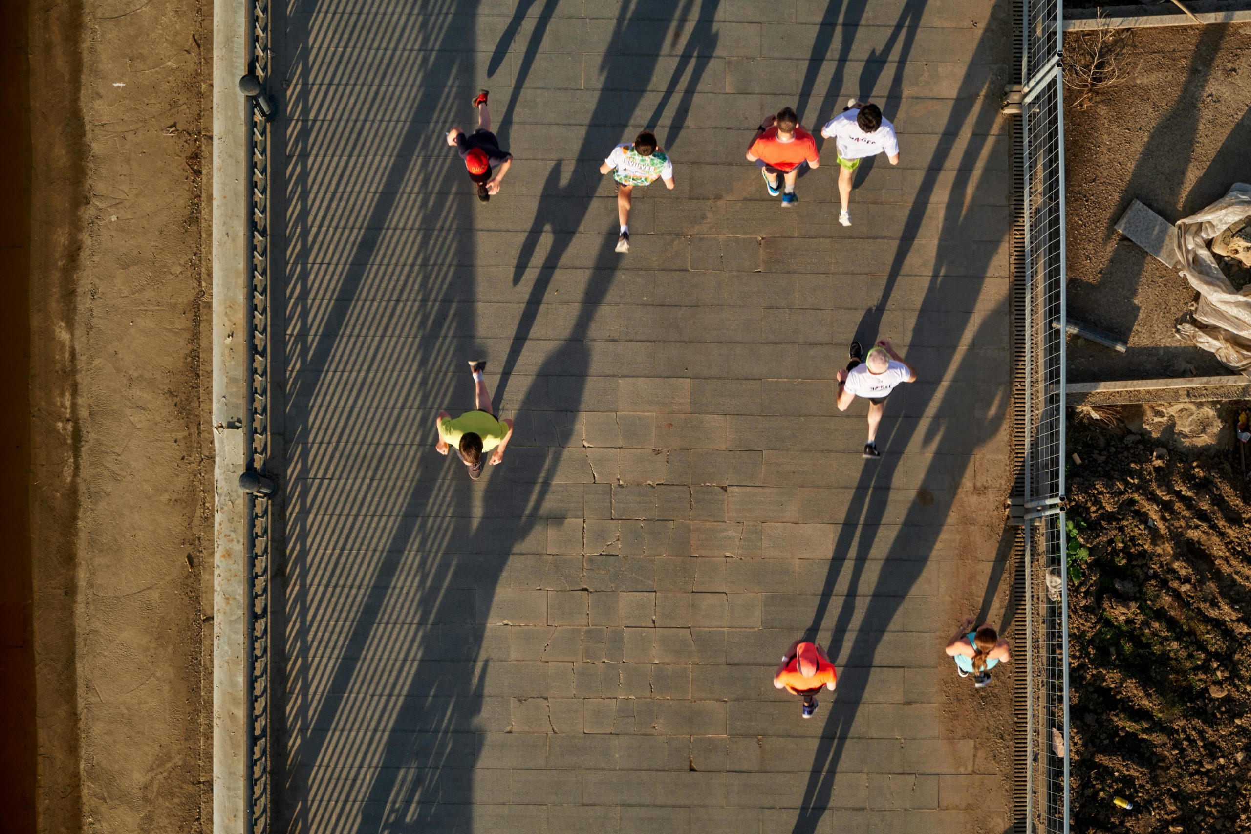 Group of diverse people high-fiving after a workout session, smiling and sweaty, visible camaraderie
