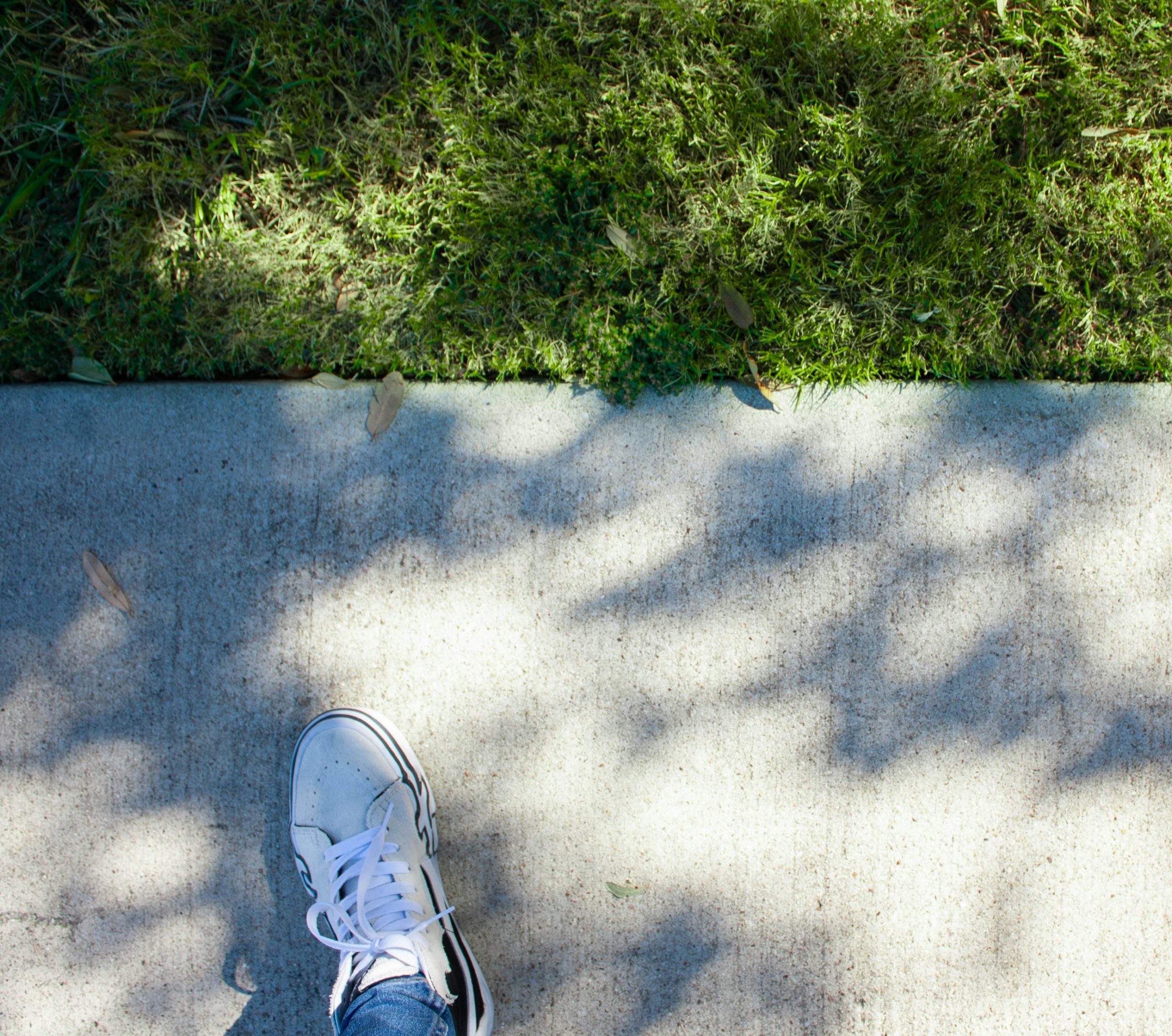 Close up of running shoes on a trail path, dynamic angle showing action