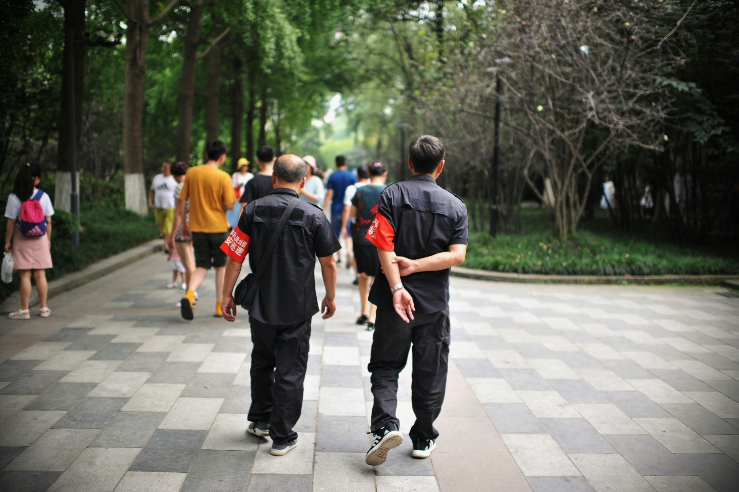 People walking rapidly in a park with fitness clothes, low angle view