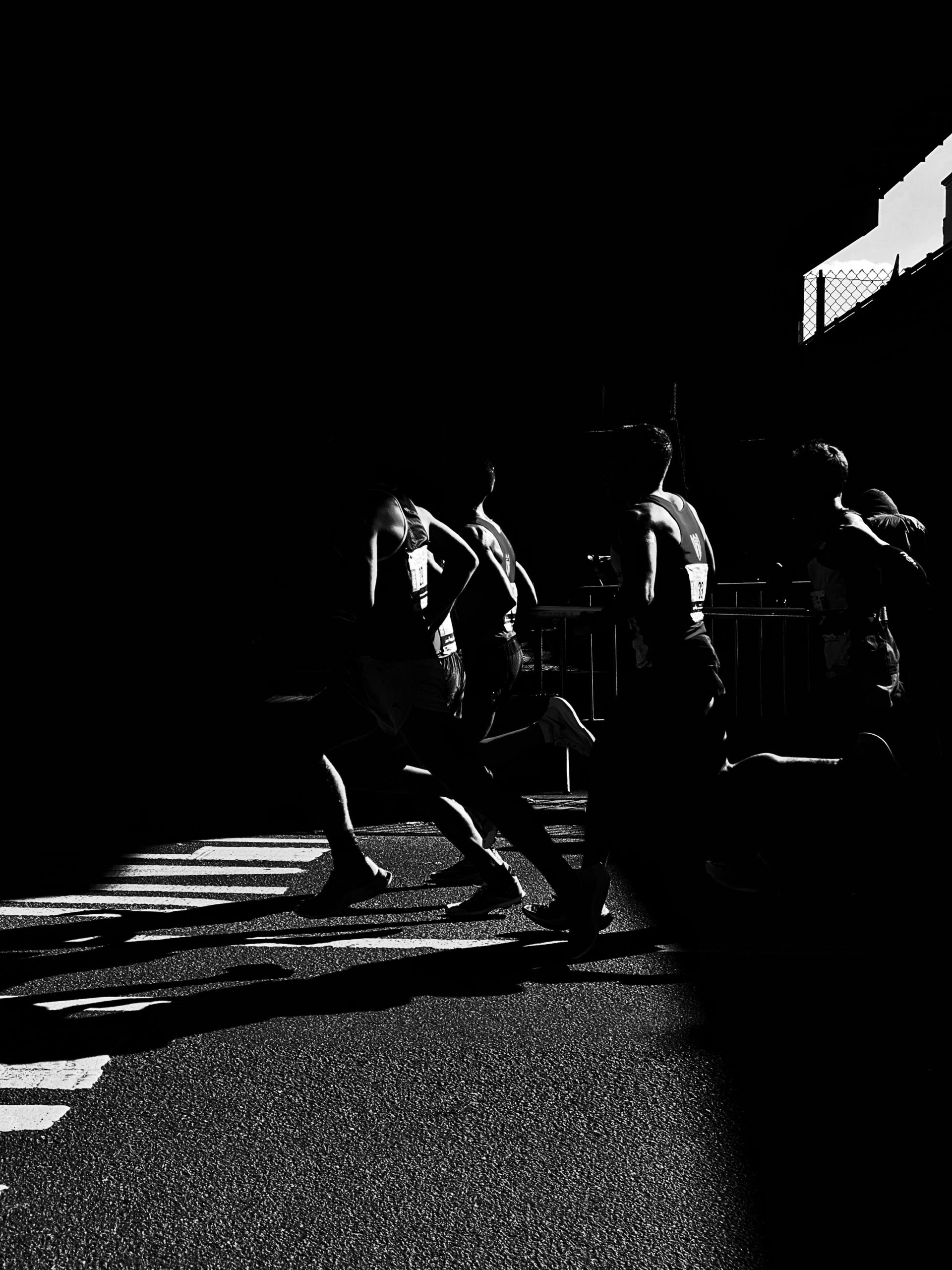 Group of people running in a gym or track, motion blur