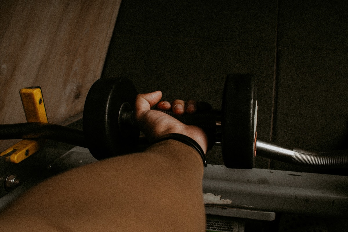 a person lifting a barbell in a gym
