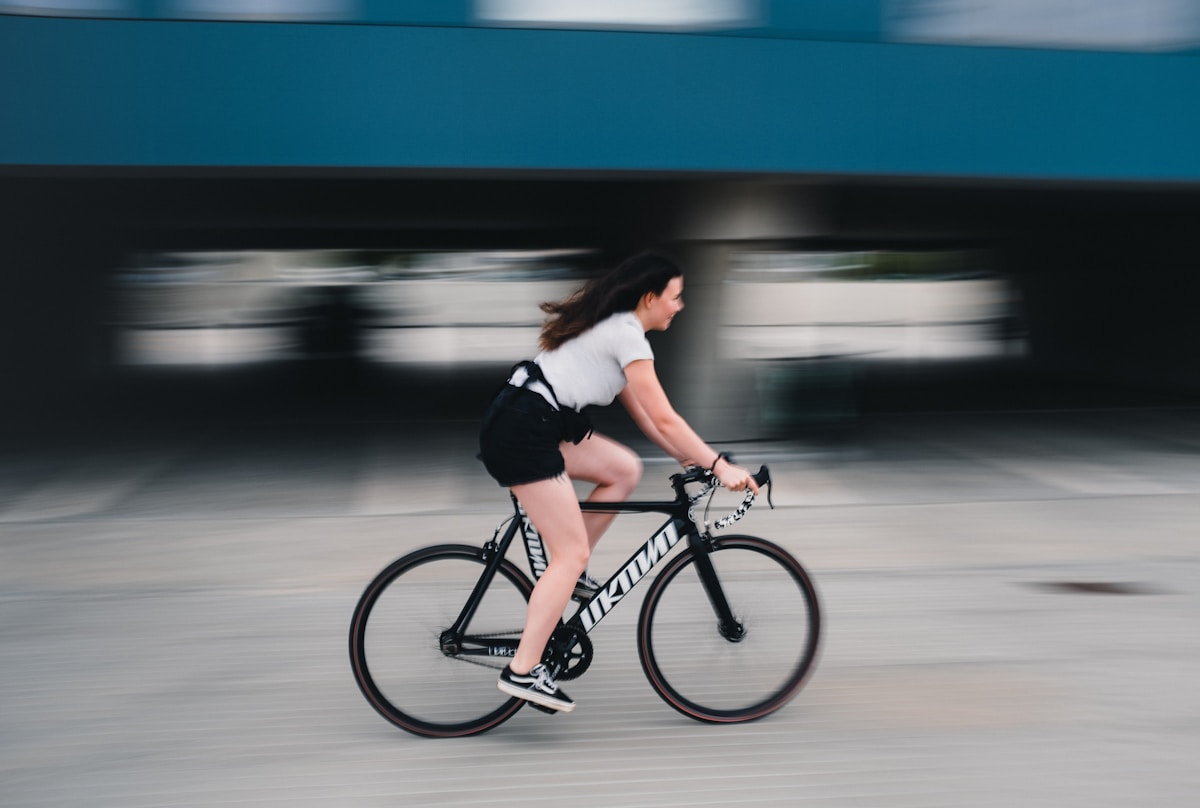 Cycliste féminine en mouvement sur un vélo de course.