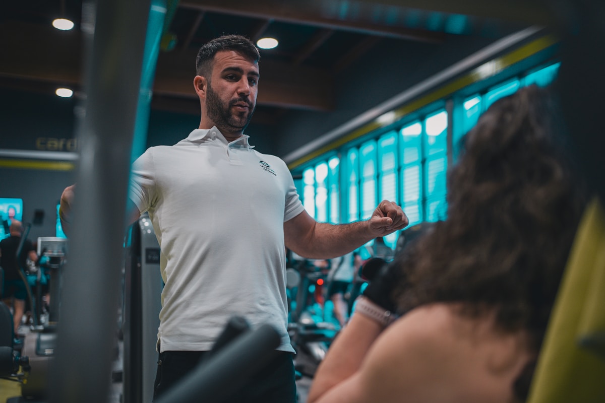 Un homme barbu en tenue de sport dans une salle de gym.